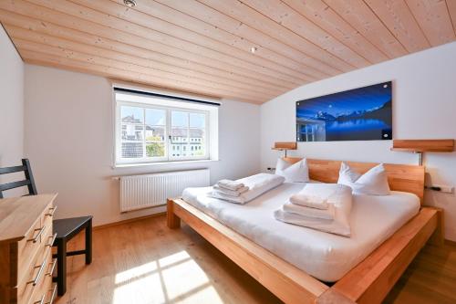 a bedroom with a large bed with white pillows at Ferienwohnung Rommel in Pfronten