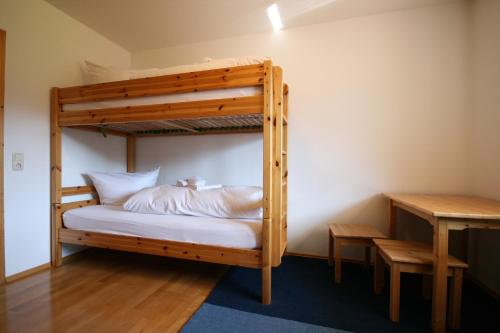 a bunk bed in a room with a desk at Ferienwohnung Romi in Pfronten
