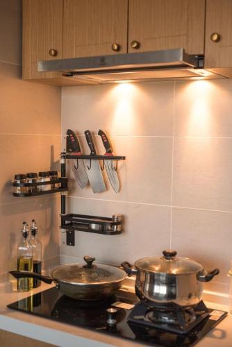 a kitchen with two pots and pans on a stove at Dali Dream House with Seaview in Dali