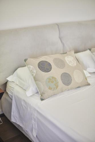 a white bed with a pillow on top of it at Borgo della Spiga - Adult Friendly Country House in Cervidone