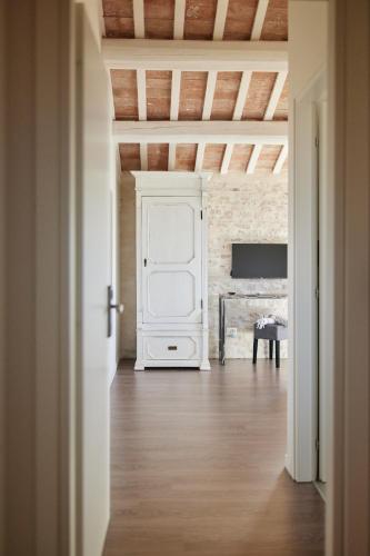an empty room with a white cabinet and a brick wall at Borgo della Spiga - Adult Friendly Country House in Cervidone