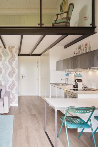 a kitchen with a white table and a blue chair at Borgo della Spiga - Adult Friendly Country House in Cervidone