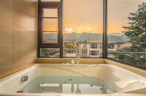 a bath tub in a bathroom with a window at Dali Dream House with Seaview in Dali