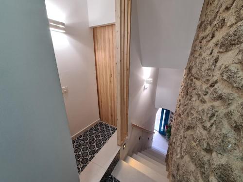 a hallway with a stone wall and a stairway at El Edén Casas Rurales con Piscina y Jacuzzi in Montánchez