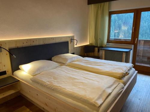 a bed with two pillows on it in a bedroom at Gasthof Mühle in Wattens