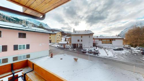 a view from the balcony of a building with snow at Rosatsch 14 in Surlej