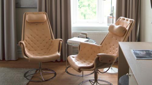 two chairs and a table in a room at TwentySix in Malmö