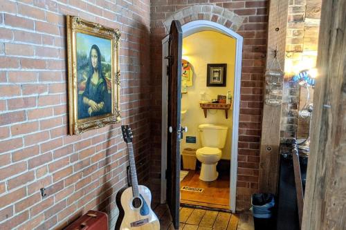 奧蘭治維爾的住宿－A charming, rustic 150 year old Carriage House，一间带卫生间的浴室和墙上的绘画