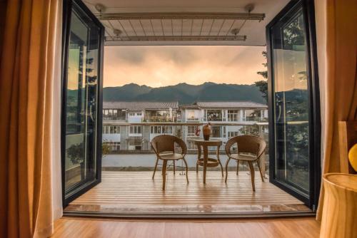 a balcony with two chairs and a table with a view at Dali Dream House with Seaview in Dali