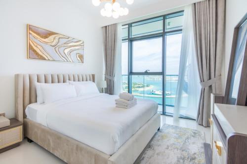 a bedroom with a bed and a large window at 2BR Amazing Palm View - Private beach - Beach Vista T1 in Dubai