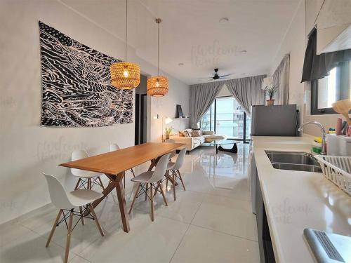 a kitchen and dining room with a wooden table and chairs at Amberside, Country Garden Danga Bay Homestay by WELCOME HOME in Johor Bahru