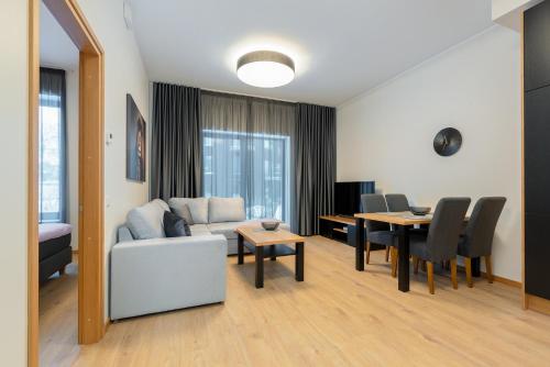 a living room with a couch and a table at TartuKodu Riia20A-8 in Tartu