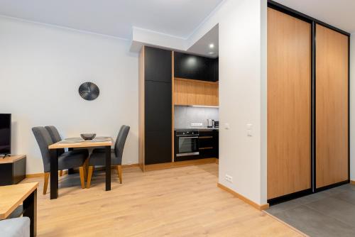 a kitchen and dining room with a table and chairs at TartuKodu Riia20A-8 in Tartu