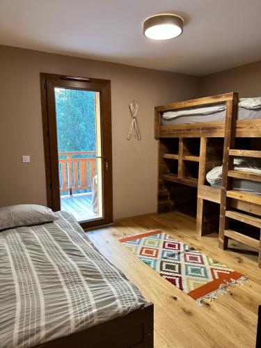 a bedroom with two bunk beds and a balcony at Gorgeous 2 bedroom, 2 full bath, ski in apartment! in Morzine