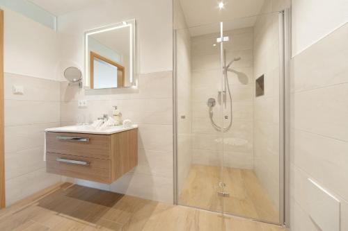 a bathroom with a shower and a sink at Landhaus am See Appartement LH 03 in Schwangau