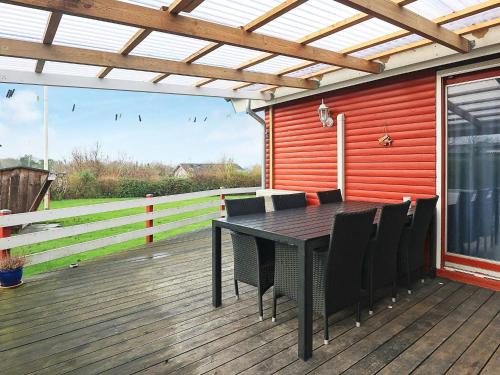 a patio with a table and chairs on a deck at 6 person holiday home in Vinderup in Vinderup