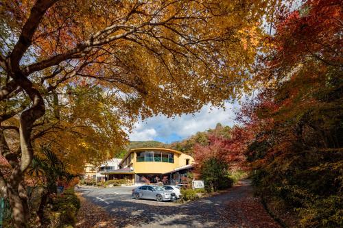 a house with a car parked in front of it at Iwasu-so in Nakatsugawa