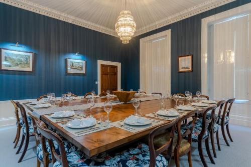 a dining room with a long table and chairs at Leonard Stanley House in Stonehouse