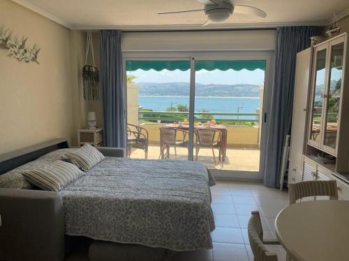 a bedroom with a bed and a view of the ocean at Residencial Vistamar in Santoña