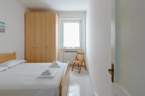 a bedroom with a bed and a chair and a window at Vallevo 42 - YourPlace Abruzzo in San Vito Chietino