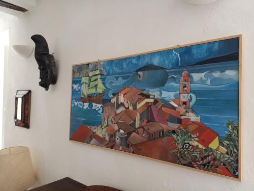 a painting hanging on a wall in a room at Borgo Antico - Casa del Caruggio in Tellaro