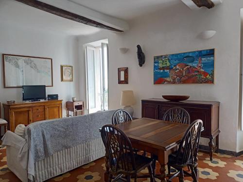 a living room with a table and a couch at Borgo Antico - Casa del Caruggio in Tellaro