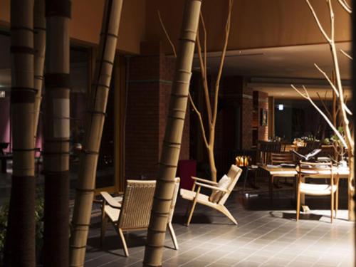 a restaurant with chairs and tables in a building at Sanyoan in Otofuke