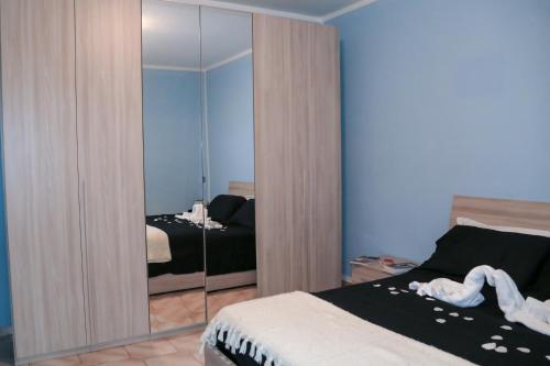 1 Schlafzimmer mit 2 Betten und einem großen Spiegel in der Unterkunft Guest House Romero in Cadelbosco di Sotto