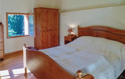 a bedroom with a large bed and a window at Beautiful Home In Gonfaron With 4 Bedrooms, Wifi And Private Swimming Pool in Gonfaron