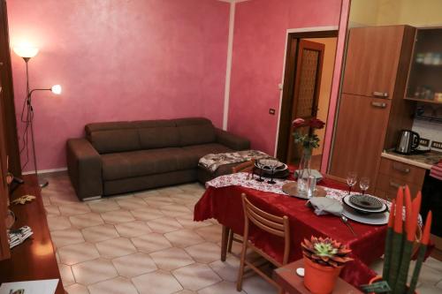 a living room with a table and a couch at Guest House Romero in Cadelbosco di Sotto