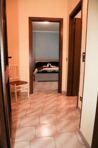 a hallway with a bedroom with a bed in the background at Guest House Romero in Cadelbosco di Sotto