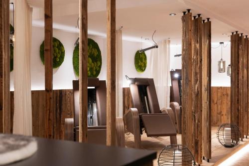 a dining room with wooden walls and a table and chairs at Hotel Brugger in Fulpmes