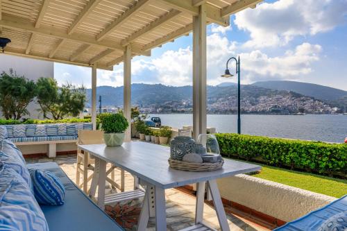 a table on a patio with a view of the water at Skopelos Village Hotel in Skopelos Town