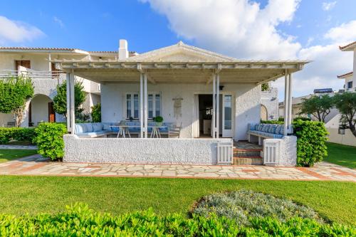 a house with a porch with a patio at Skopelos Village Hotel in Skopelos Town