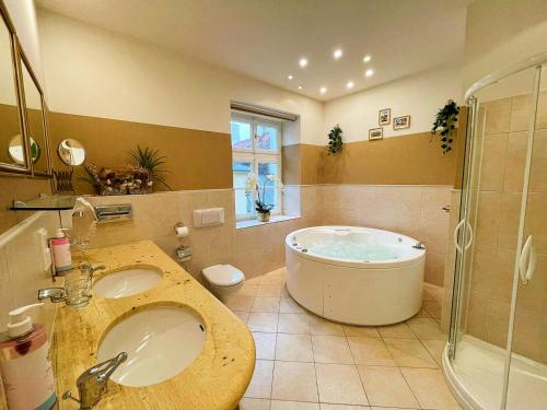 a bathroom with a tub and a sink and a shower at Great Polonia Kraków Old Town in Kraków