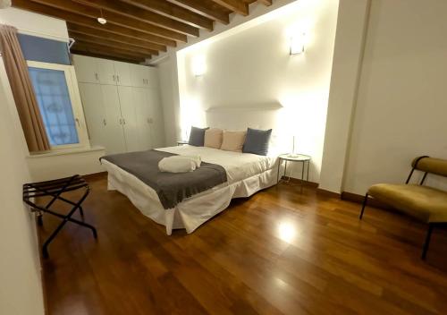 a bedroom with a large bed and a wooden floor at ISA Granada in Granada