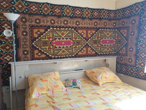 a bedroom with a bed and a wall with a pattern at Casa Rustic in Vama
