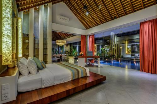 a bedroom with a large bed in a room at Villa Banyu in Seminyak