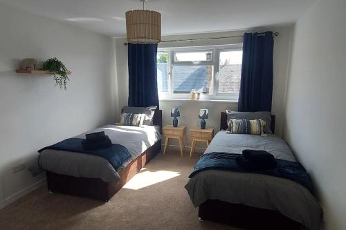 a bedroom with two beds and a window at ZARA APARTMENTS PT 3 in Dundee