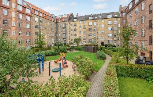a playground in front of a large building at 1 Bedroom Cozy Apartment In Aarhus C in Aarhus