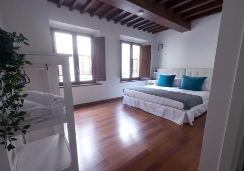 a bedroom with a bed with blue pillows at ISA Granada in Granada