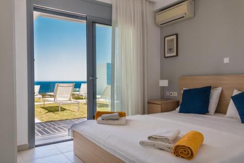 a bedroom with a bed with a view of the ocean at Villa Aristoteles in Líndos