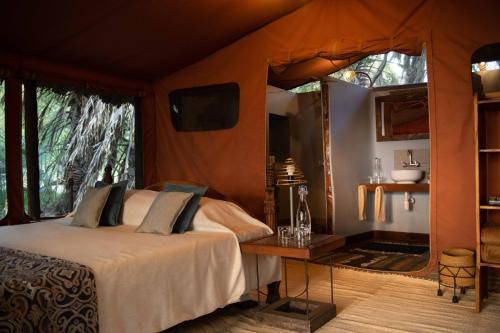 a bedroom with a bed in a tent at Kisima Ngeda Camp in Mangola