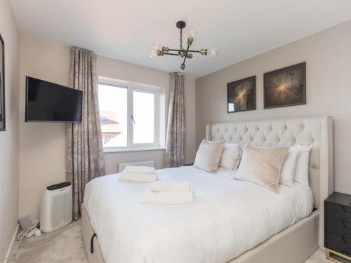 a bedroom with a large white bed and a window at Serene Home in Leafy Warfield w Private Garden - Pass the Keys in Bracknell