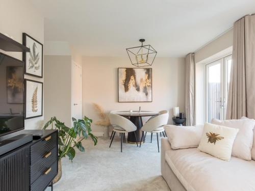 a living room with a couch and a table at Serene Home in Leafy Warfield w Private Garden - Pass the Keys in Bracknell