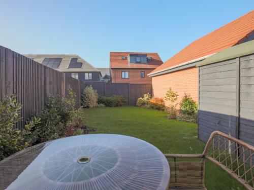 a patio table with an umbrella on a backyard at Serene Home in Leafy Warfield w Private Garden - Pass the Keys in Bracknell