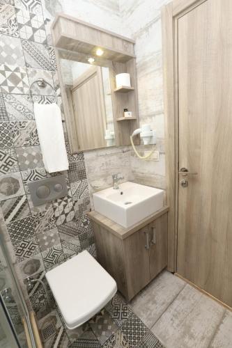a bathroom with a sink and a toilet and a mirror at Street61 Apart Hotel in Sarigerme