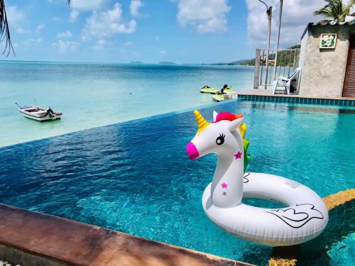 une piscine avec un flotteur de maïs dans l'eau dans l'établissement Rin Bay View Resort, à Haad Rin