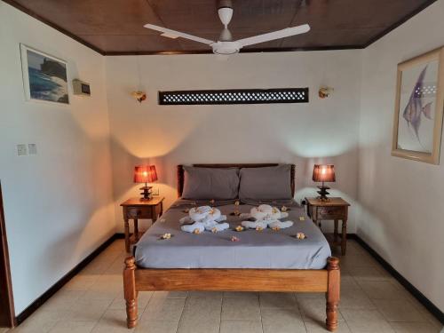 a bedroom with a bed with two night stands at Mirella Villa in Praslin