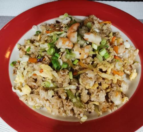a red bowl of rice with shrimp and vegetables at Sulu Sunset Beach Resort in Nauhang
